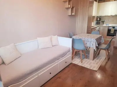 a small room with a bed and a table at LevskiG Family Flat 10 min from Sofia Airport and city center in Sofia