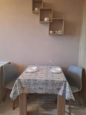 a table with a table cloth on it with chairs at LevskiG Family Flat 10 min from Sofia Airport and city center in Sofia