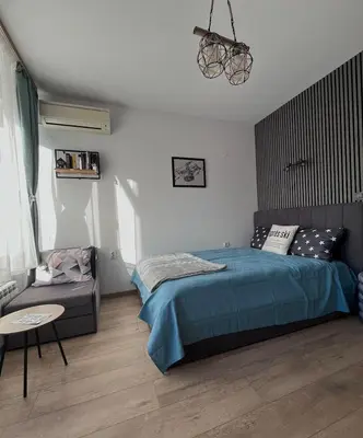 a bedroom with a bed and a couch at Mountain View Studio Borovets Hills A60 in Borovets