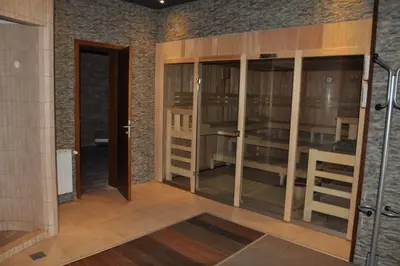a room with glass doors and a brick wall at Mountain View Studio Borovets Hills A60 in Borovets