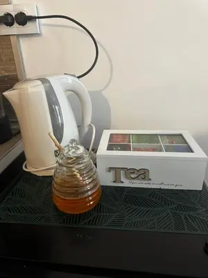 a tea kettle and a box on a table at Winter Lotos Apartment Pamporovo in Pamporovo