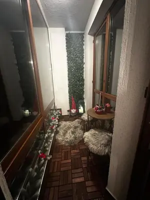 a hallway with christmas decorations on the floor and a table at Winter Lotos Apartment Pamporovo in Pamporovo