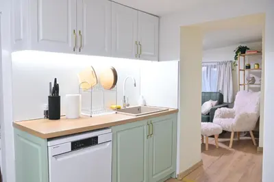 a kitchen with white cabinets and a sink at Villa Natalia in Kremen