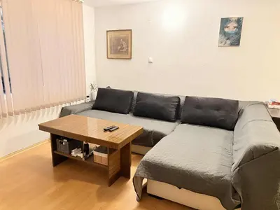 a living room with a couch and a coffee table at Cozy two room maisonette apartment in Samokov