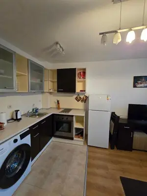 a kitchen with a washing machine and a washer at Апартамент Kosara 44 in Bansko