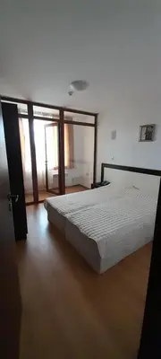 a bedroom with a large bed in a room at Апартамент Kosara 44 in Bansko