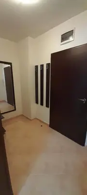 an empty room with a large black door in it at Апартамент Kosara 44 in Bansko