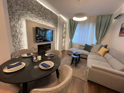 a living room with a table and a couch at Celestial Stylish Central 2BDR w WiFi and Work Space in Sofia