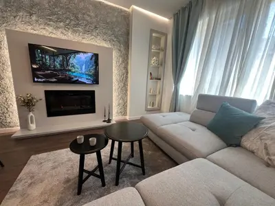 a living room with a couch and a tv at Celestial Stylish Central 2BDR w WiFi and Work Space in Sofia