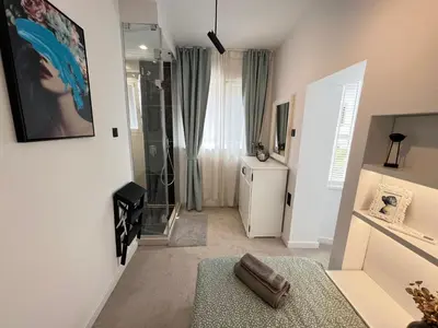 a bathroom with a walk in shower and a glass shower at Celestial Stylish Central 2BDR w WiFi and Work Space in Sofia