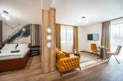 a bedroom with a bed and a chair and a table at Best Central Lux Studio in Bansko