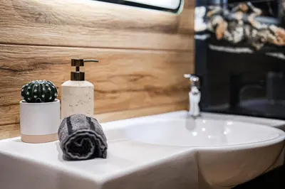 a bathroom with a sink and a toilet paper dispenser at Best Central Lux Studio in Bansko