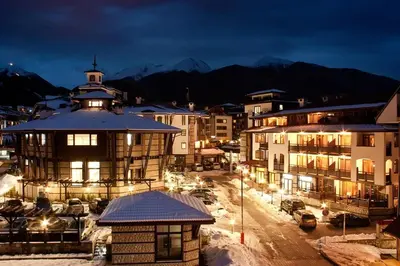 a city at night with cars parked in a parking lot at Best Central Lux Studio in Bansko