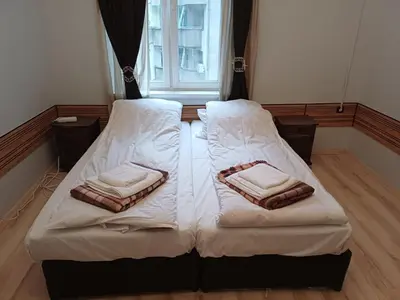 two twin beds in a room with a window at Ktt house in Plovdiv