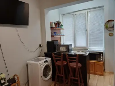a kitchen with a washing machine and a microwave at Ktt house in Plovdiv