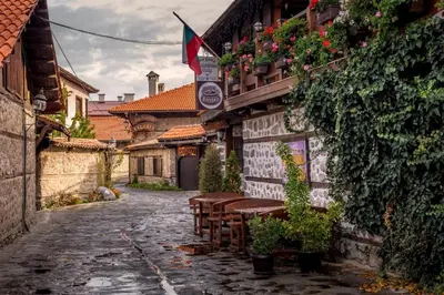 an alley with tables and chairs on a building at Best Central LUX Studio in Bansko
