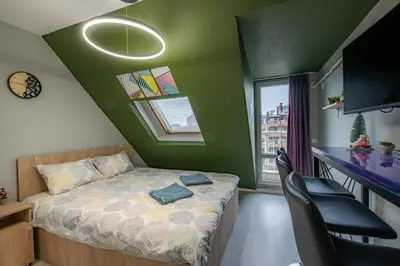 a bedroom with a bed and a green wall at Comfy&Chick Central Apartment, Free Street Parking in Blagoevgrad