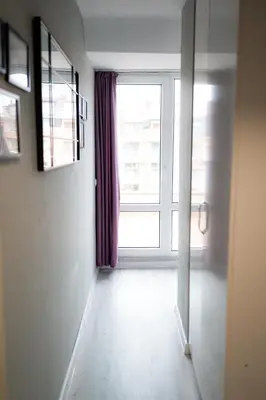 an empty hallway with a large window in a building at Comfy&Chick Central Apartment, Free Street Parking in Blagoevgrad