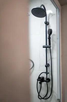 a shower with a shower head in a bathroom at Comfy&Chick Central Apartment, Free Street Parking in Blagoevgrad