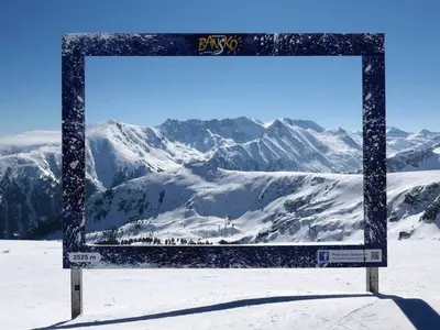 a sign in the snow with mountains in the background at Best Central LUX Studio in Bansko