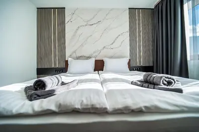 a bedroom with a large bed with towels on it at Best Central LUX Studio in Bansko