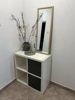 a white dressing table with a mirror and a vase at Angels Loft opposite The Mall in Sofia