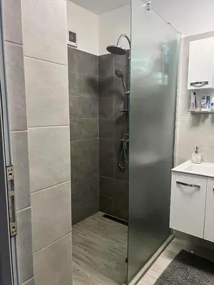 a shower with a glass door in a bathroom at Angels Loft opposite The Mall in Sofia