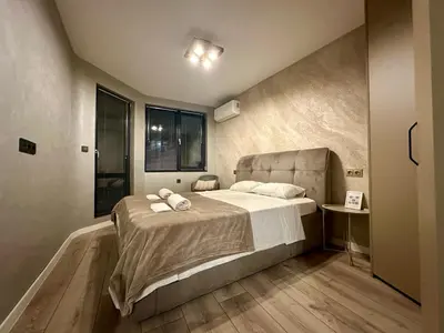 a bedroom with a bed with two towels on it at Casa Nova with Free Garage Parking in Plovdiv
