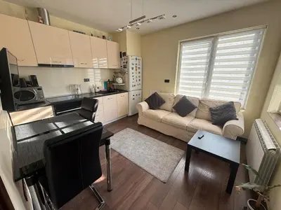 a living room with a couch and a kitchen at Pasarel House in Pasarel