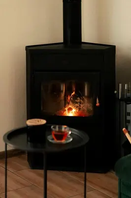 a black fireplace with a table in front of it at Guest house ''Viktoria'' in Simitli