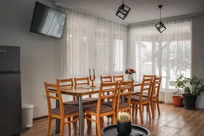 a dining room with a table and chairs at Guest house ''Viktoria'' in Simitli