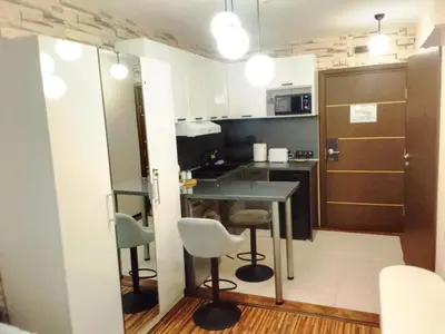 a small kitchen with a table and two chairs at Luxury studio Perun Lodge in Bansko