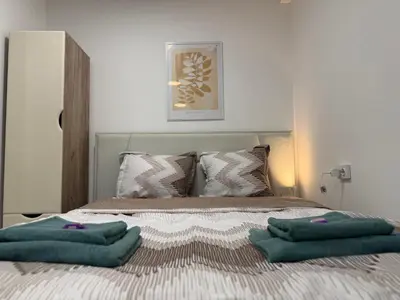 a bed with two green pillows on top of it at Botev MiniHub Hub 2 Modern Studio at Botev 88 in Sofia
