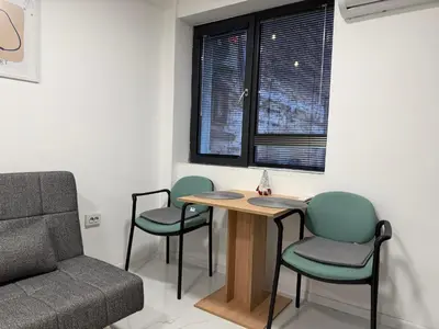 a room with a table and chairs and a couch at Botev MiniHub Hub 2 Modern Studio at Botev 88 in Sofia
