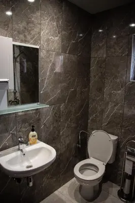 a bathroom with a toilet and a sink at Dzhorgovata Guesthouse in Govedartsi