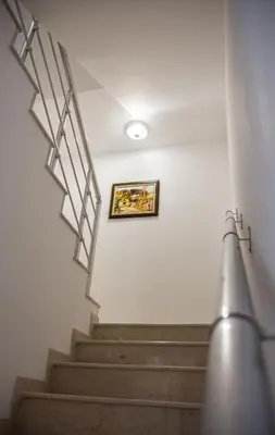 a staircase in a building with a picture on the wall at Dzhorgovata Guesthouse in Govedartsi