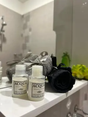 two bottles on a shelf in a bathroom at Vinny's Place in Sofia