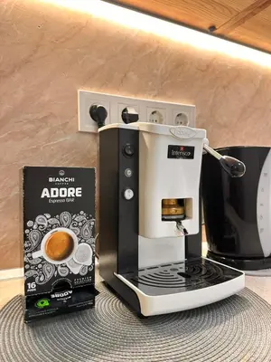 a coffee maker sitting on a counter next to a box at Vinny's Place in Sofia
