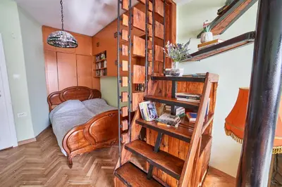 a room with a bed and a book shelf at Fabulous Retro Apartment in the Heart of Sofia in Sofia