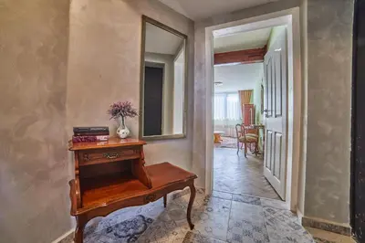 a hallway with a wooden table and a mirror at Fabulous Retro Apartment in the Heart of Sofia in Sofia