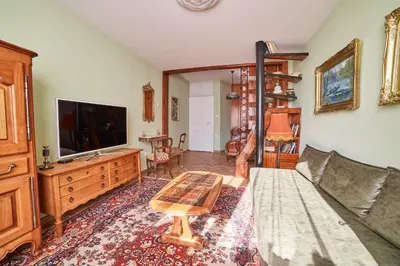 a living room with a couch and a tv at Fabulous Retro Apartment in the Heart of Sofia in Sofia