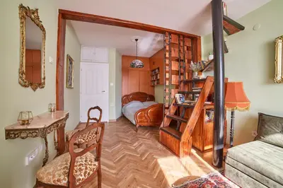 a living room with a room with a bed and a couch at Fabulous Retro Apartment in the Heart of Sofia in Sofia