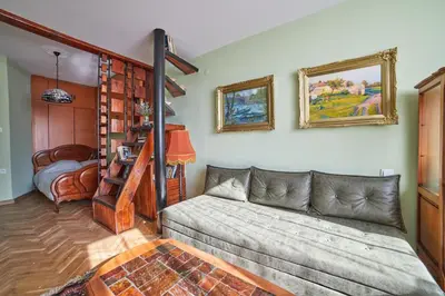 a living room with a couch and a bunk bed at Fabulous Retro Apartment in the Heart of Sofia in Sofia