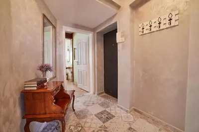 a hallway with a wooden desk and a door at Fabulous Retro Apartment in the Heart of Sofia in Sofia
