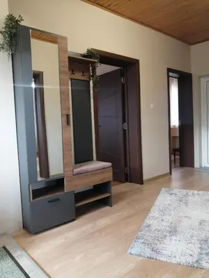 a dressing room with a large mirror and a rug at Уют in Haskovo
