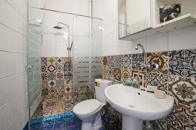 a bathroom with a toilet and a sink at Heart of Sofia 2 Bdr Elevator Balcony Relax in Sofia