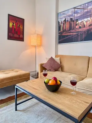 a living room with a bowl of fruit on a coffee table at Heart of Sofia 2 Bdr Elevator Balcony Relax in Sofia