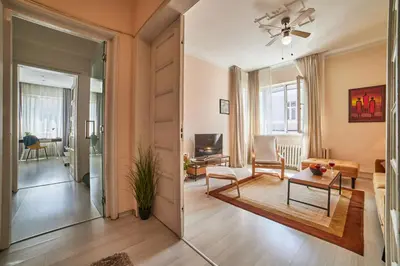 a living room with a couch and a table at Heart of Sofia 2 Bdr Elevator Balcony Relax in Sofia