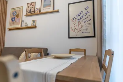 a dining room table with a white table cloth on it at Bright and Cozy Apartment at a quiet Location in Sofia