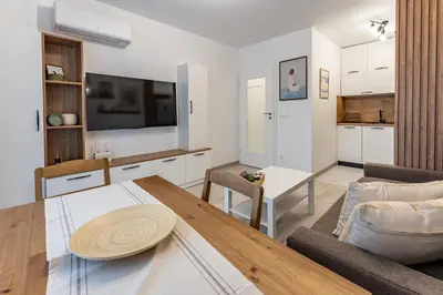 a living room with a couch and a table at Bright and Cozy Apartment at a quiet Location in Sofia